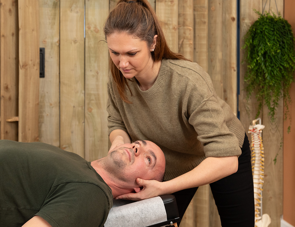 DC Jessica Payne treating a mans neck