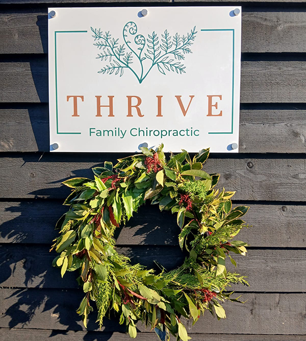 Thrive Studio Sign with Garland
